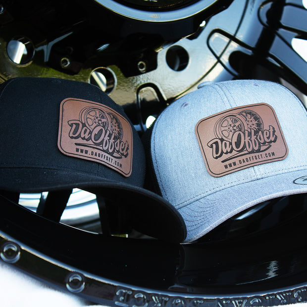 Two snapback hats with leather patches