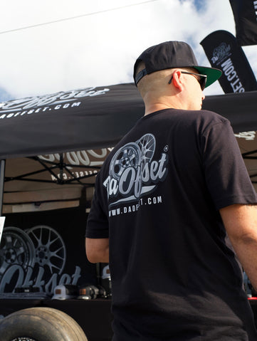 Man wearing Da Offset branded t-shirt and snapback at outdoor truck event