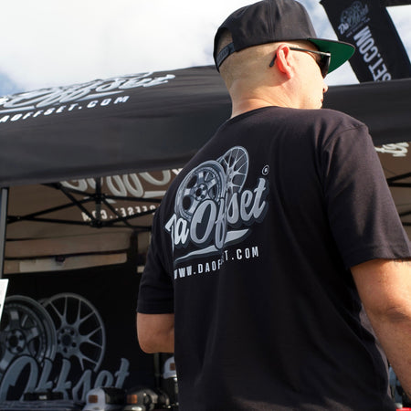 Man wearing Da Offset branded t-shirt and snapback at outdoor truck event